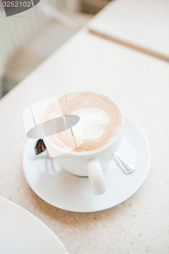 Image of Cup of delicious coffee with a heart