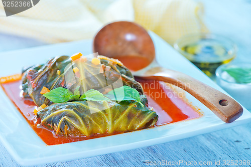 Image of dolma with tomato sauce