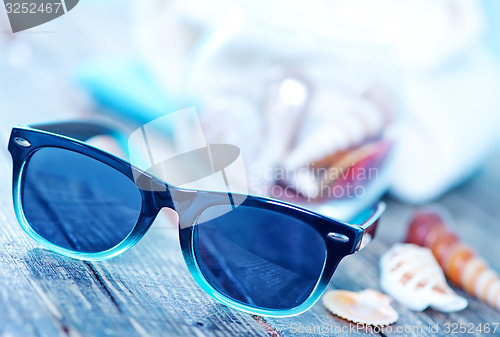 Image of sun glasses and flip flops 