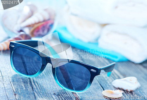 Image of sun glasses and flip flops 