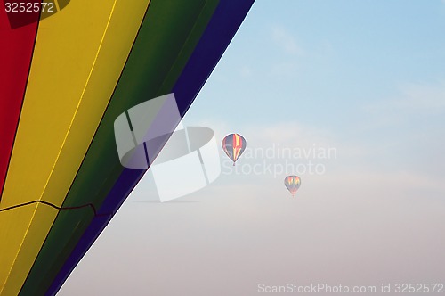 Image of hot air balloons in the morning fog