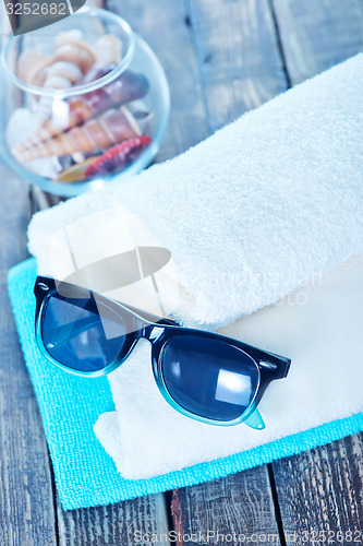 Image of sun glasses and flip flops 