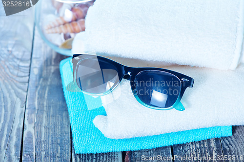 Image of sun glasses and flip flops 