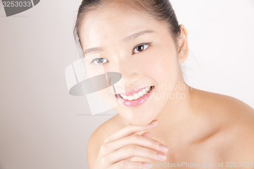 Image of no captionBeautiful young Asian girl with one hand on face