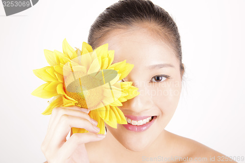 Image of Beautiful young Asian girl with bright yellow sunflower