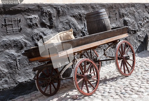 Image of old wooden cart on background of brick wall