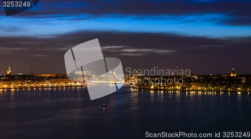 Image of Stockholm at night with light reflection in water