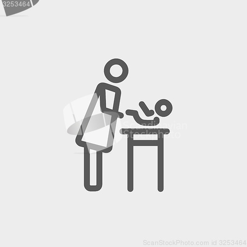 Image of Woman changing the diaper thin line icon