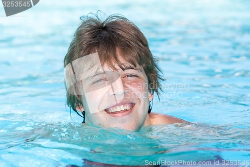 Image of Happy man  in a swimming pool 