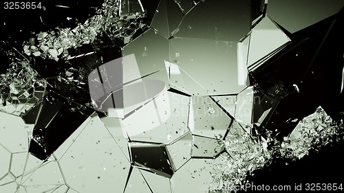 Image of Cracked and damaged glass pieces on black