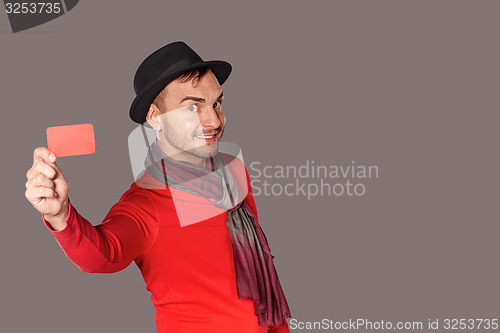 Image of Smiling casual man showing blank credit card