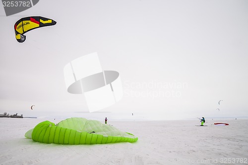 Image of Kiteboarder with kite on the snow