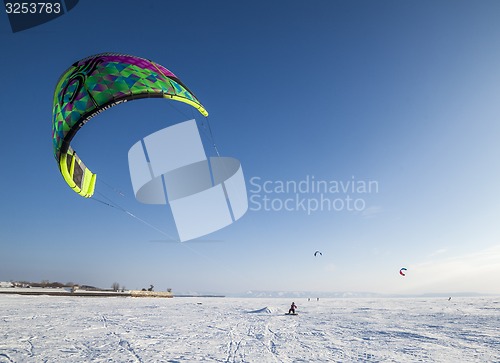 Image of Kiteboarder with kite on the snow