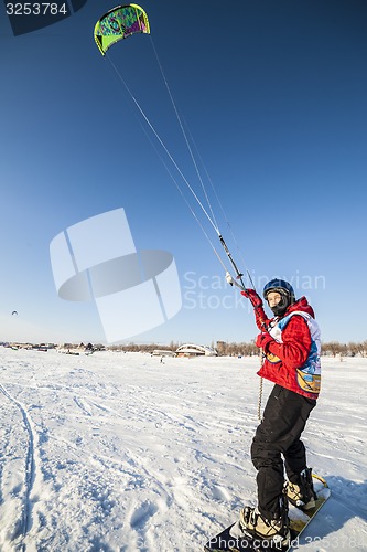 Image of Kiteboarder with kite on the snow