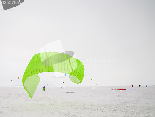 Image of Kiteboarder with kite on the snow