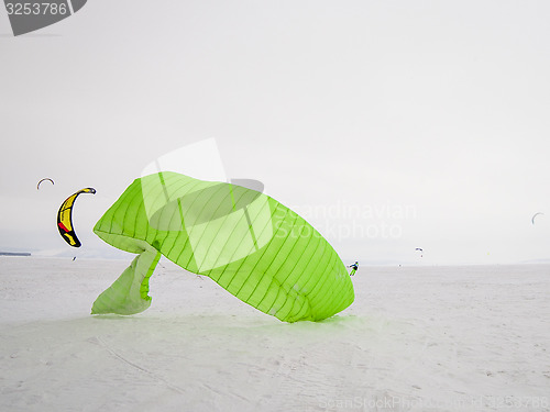 Image of Kiteboarder with kite on the snow