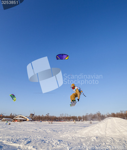 Image of Kiteboarder with kite on the snow