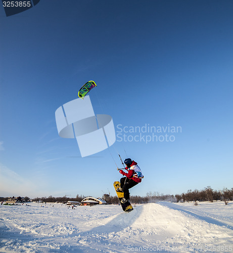 Image of Kiteboarder with kite on the snow