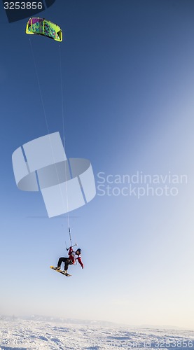 Image of Kiteboarder with kite on the snow