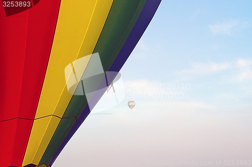 Image of hot air balloons floating in the morning sky