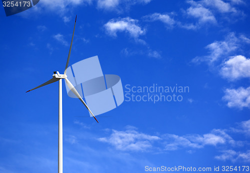 Image of Wind turbine and blue sky with clouds