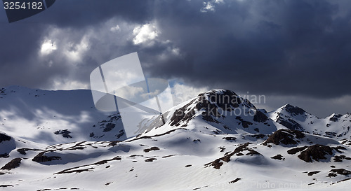 Image of Panoramic view of snow mountains before storm