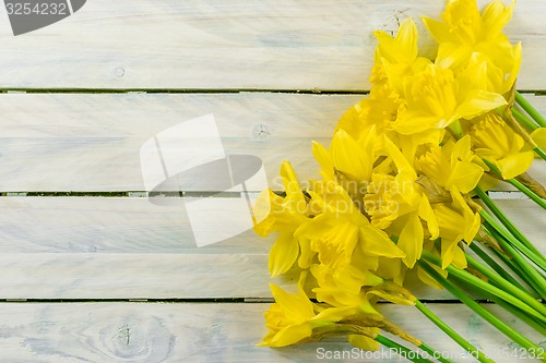 Image of Daffodils flowers on wood