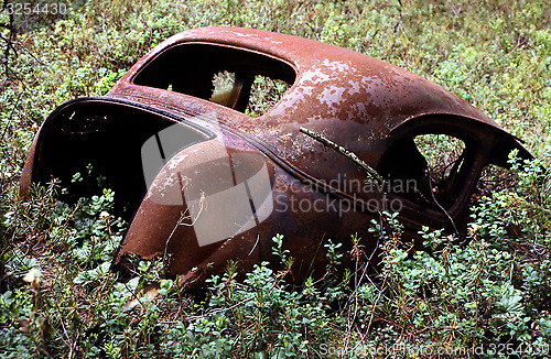 Image of Old rusty car in disintegration.