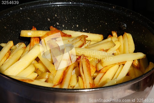 Image of Roasted potato chips in a metal frying pan