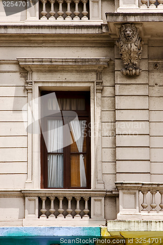 Image of  old window little terrace colors and head of lion