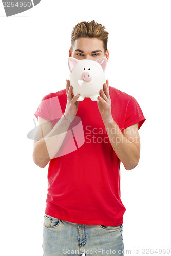 Image of Handsome young man holding a piggy bank