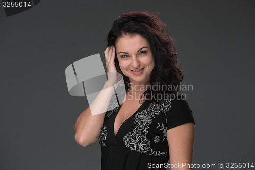 Image of Portrait of beautiful dark-haired young woman, speaking on mobile phone 