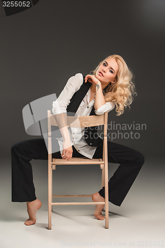 Image of Beauty blond woman on chair