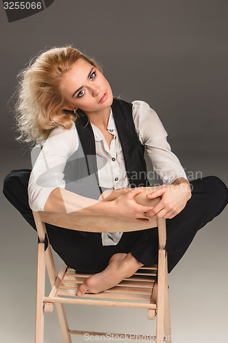 Image of Beauty blond woman on chair
