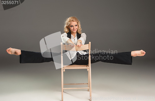 Image of Beauty blond woman on chair in ballet pose