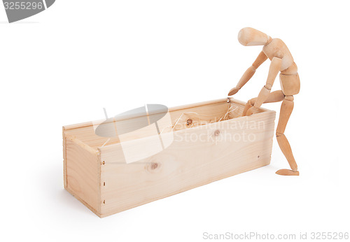 Image of Wood figure mannequin stepping in a wooden box