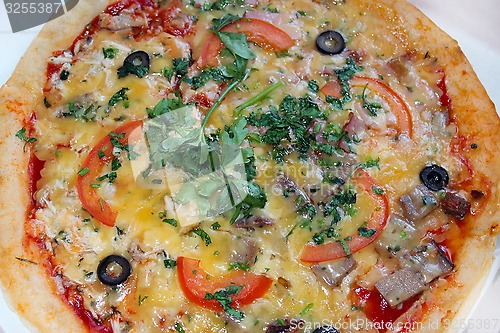 Image of pizza tasty with olives and tomatos