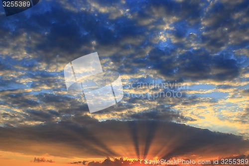 Image of beautiful summer sunset with dark sky and sun