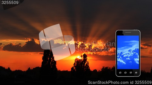 Image of beautiful summer sunset with dark sky and sun