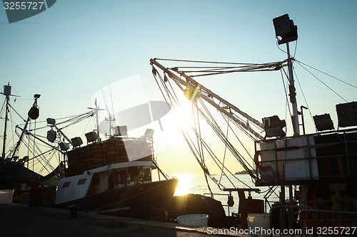 Image of Ships moored at dock in Rovinj at sunset