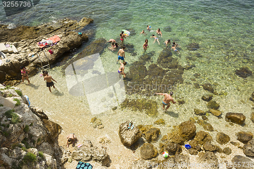 Image of People bathing on beach in Rovinj