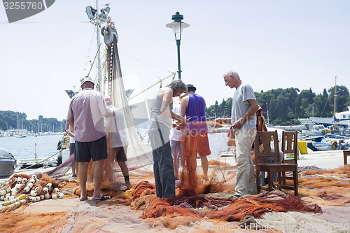 Image of Fishermen with driftnet on dock in Rovinj 