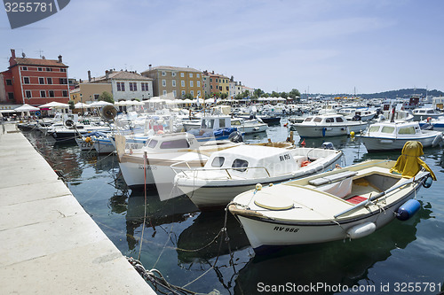 Image of Moored boats with city promenade of Rovinj in background