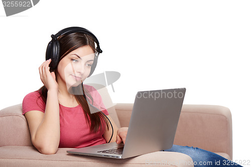 Image of Woman on sofa using laptop