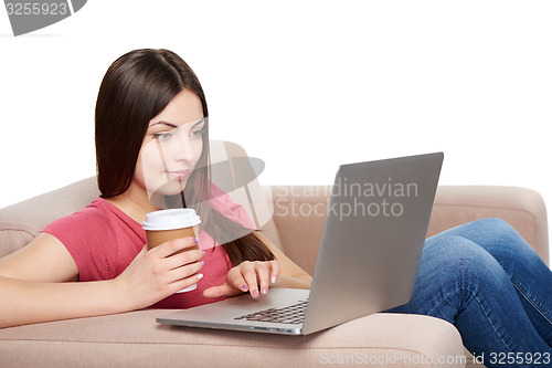 Image of Woman on sofa using laptop