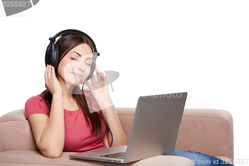 Image of Woman in headphones enjoying music