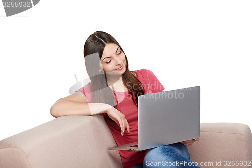 Image of Woman on sofa using laptop