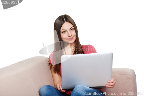 Image of Woman on sofa using laptop