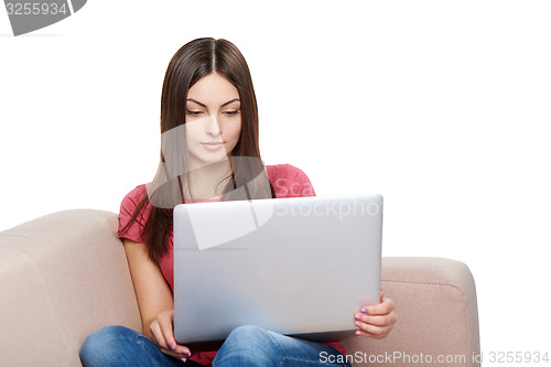 Image of Woman on sofa using laptop