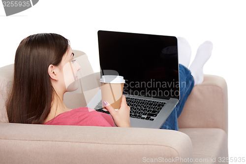 Image of Woman on sofa using laptop